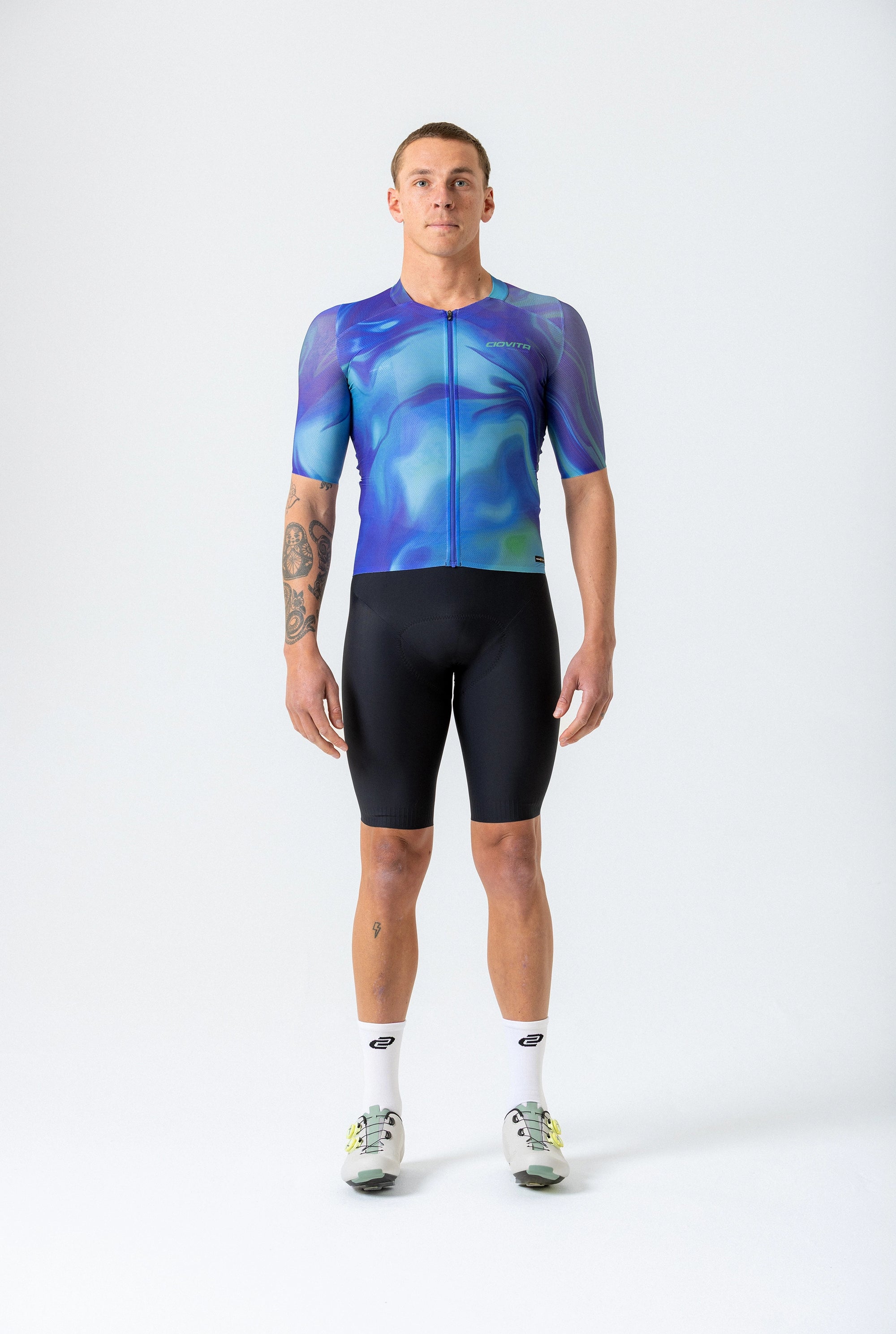 Person wearing a blue and black cycling outfit on a white background