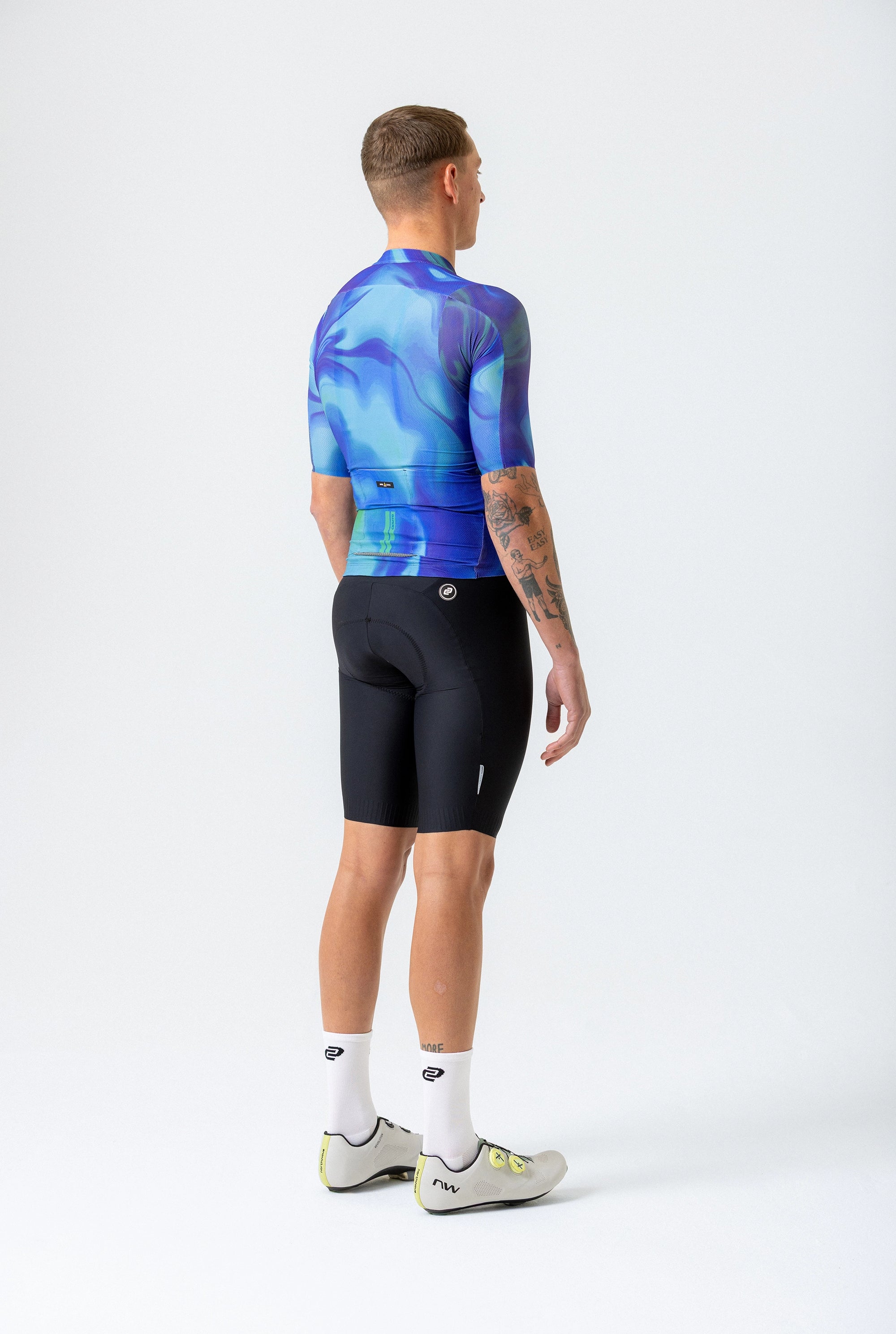 Person wearing a blue and black cycling outfit on a white background